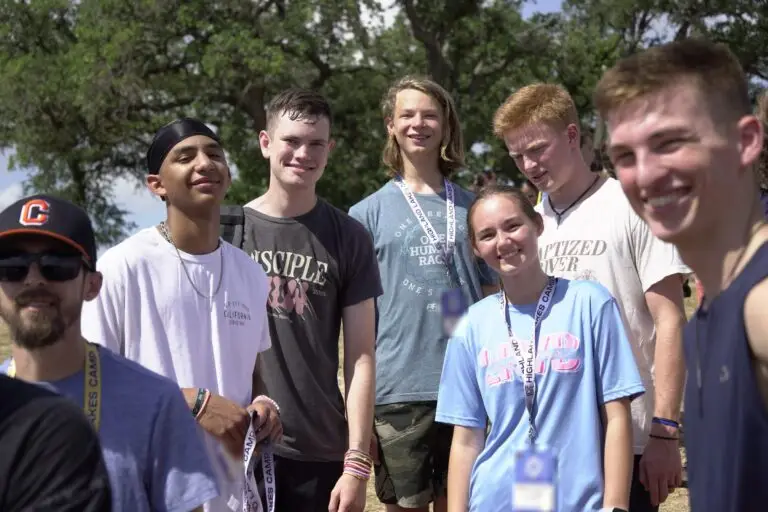 A group of Southmont students talking together outdoors at camp
