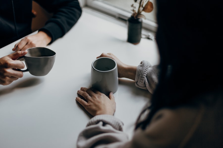 Two people in conversation over coffee